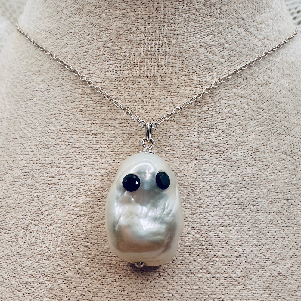 Pearl ghost with black moissanite eyes on a sterling silver chain
